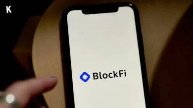 Blockfi logo on a phone on a wooden table