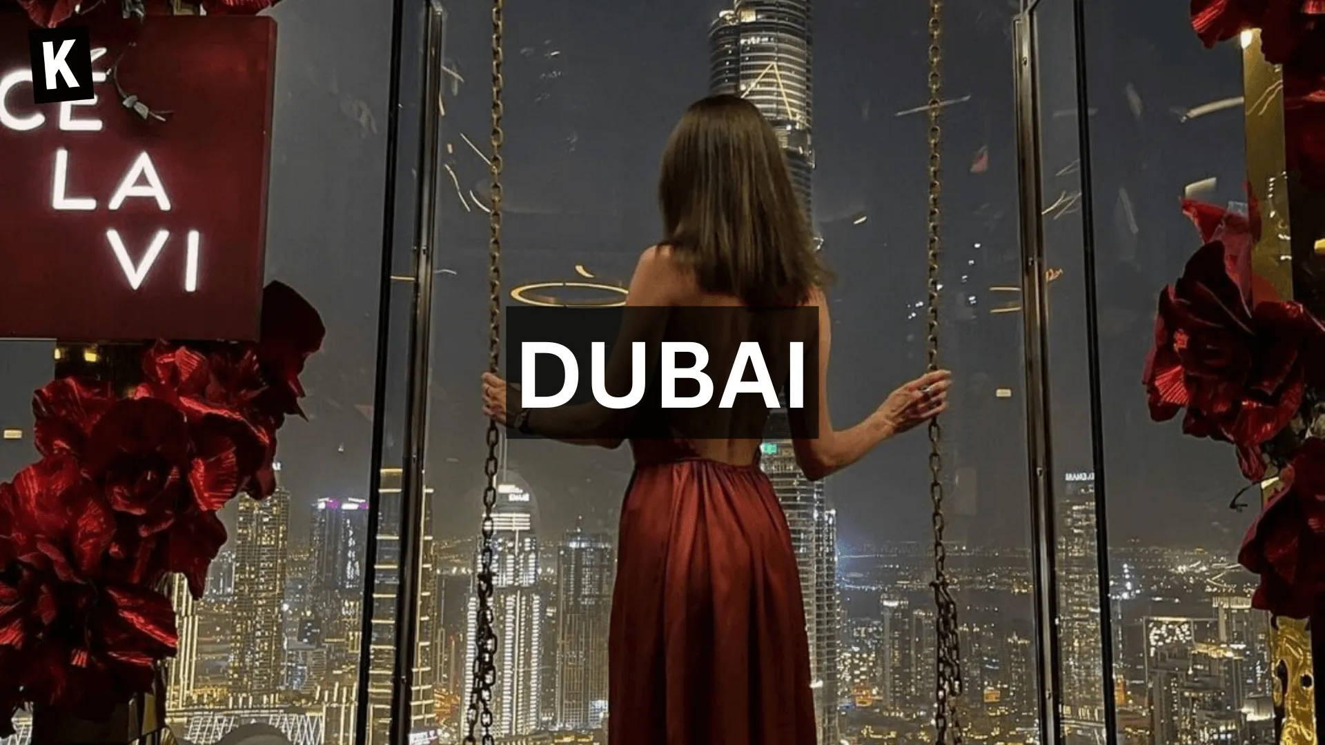 A woman in red dress in front of the swing in Ce La Vie Restaurant in Dubai