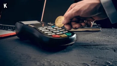Someone trying to insert a Bitcoin in a card terminal, to represent paying in crypto