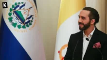 Nayib Bukele, president of El Salvador, speaking on a podium with El Salvador's flag